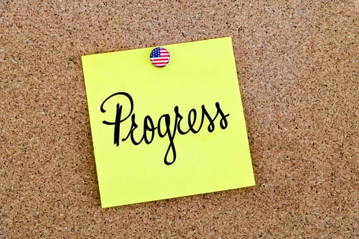 Written text Progress over yellow paper note pinned on cork board