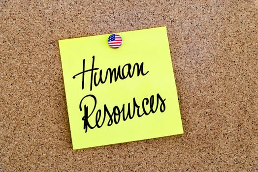 Written text Human Resources over yellow paper note pinned on cork board