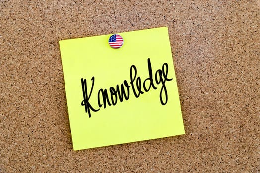 Written text Knowledge over yellow paper note pinned on cork board