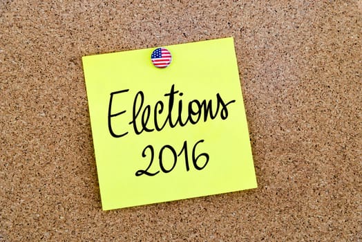 Written text Elections 2016 over yellow paper note pinned on cork board