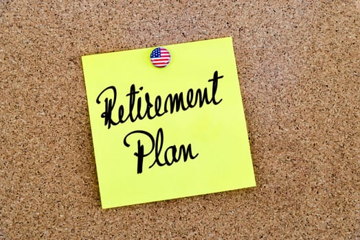 Written text Retirement Plan over yellow paper note pinned on cork board
