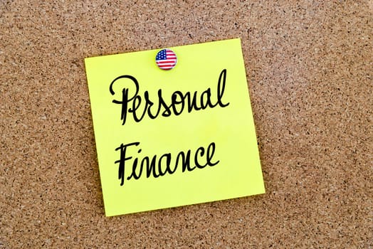 Written text Personal Finance over yellow paper note pinned on cork board