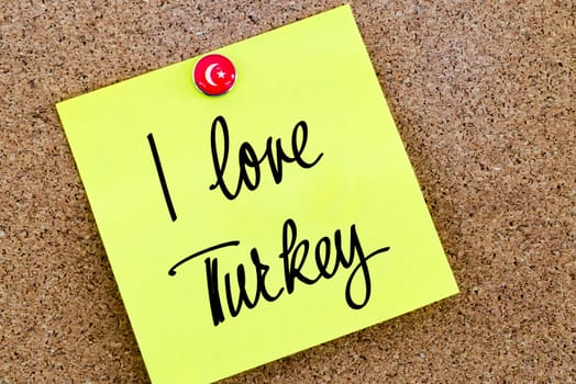 Written text I Love Turkey over yellow paper note pinned on cork board