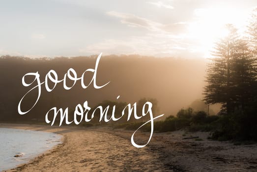 Good Morning Greeting. Handwritten motivational text over sunset calm sunny beach background with vintage filter applied