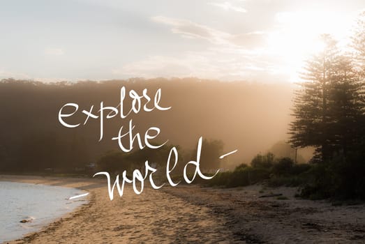 Explore The World message. Handwritten motivational text over sunset calm sunny beach background with vintage filter applied