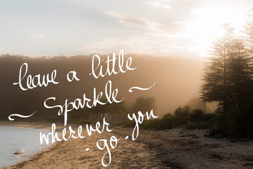 Leave A Little Sparkle wherever you Go message. Handwritten motivational text over sunset calm sunny beach background with vintage filter applied