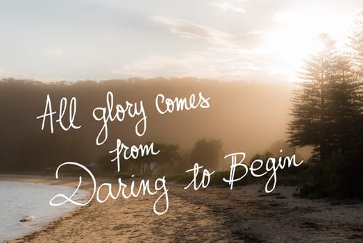 All Glory Comes From Daring To Begin message. Handwritten motivational text over sunset calm sunny beach background with vintage filter applied