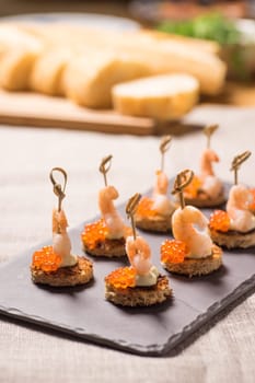 Shrimp Appetizer served on toasted bread with golden Caviar