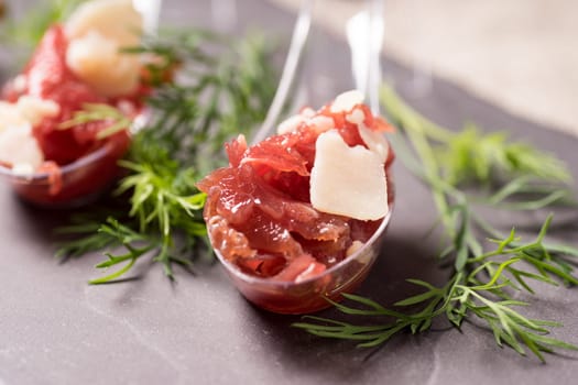 Appetizer with meat, Carpaccio and parmesan served on a Spoon