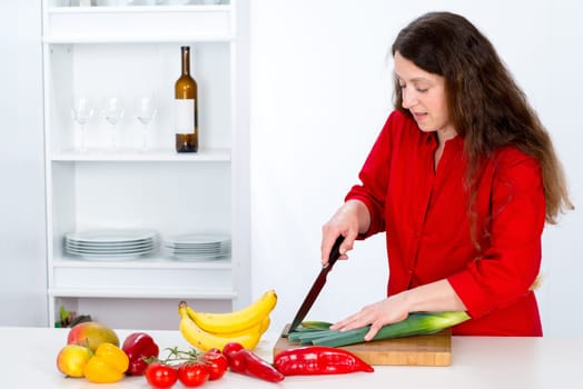 dark haired woman with red shirt in the kitchen