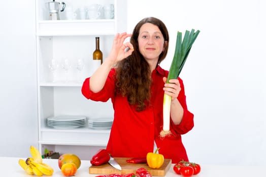 dark haired woman the kitchen showing delicious gesture