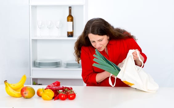dark haired woman with red shirt in the kitchen