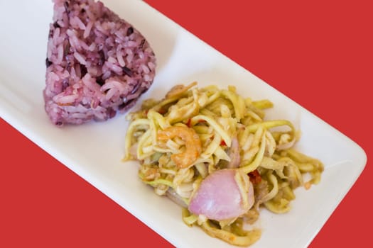 Spicy green mango salad with berry sticky rice, stock photo