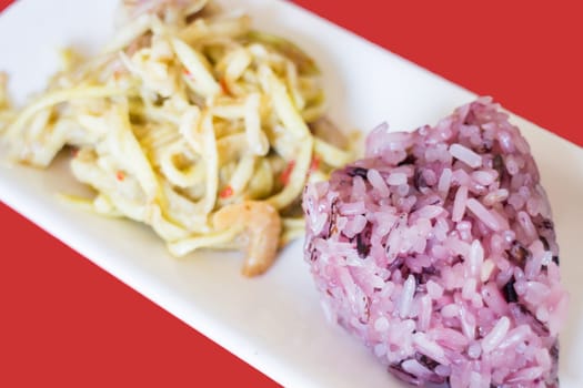 Spicy green mango salad with berry sticky rice, stock photo
