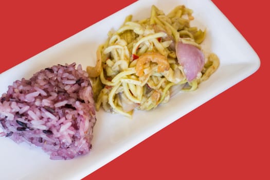 Spicy green mango salad with berry sticky rice, stock photo