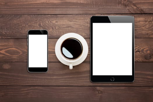 phone tablet and coffee cup on wood table top view