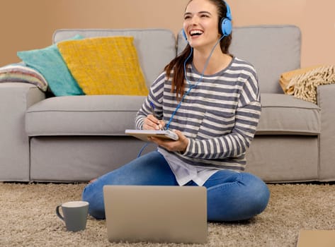 Beautiful woman at home studying while listen music