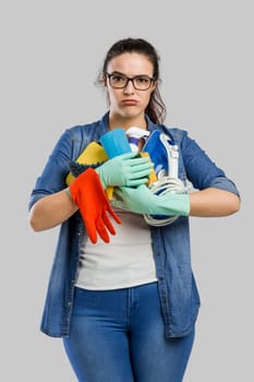 Woman portrait tired of cleaning, isolated over a gray background