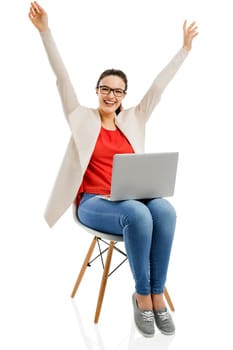 Beautiful and happy woman working with a laptop, isolated over white background