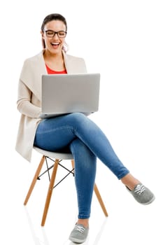 Beautiful and happy woman working with a laptop, isolated over white background