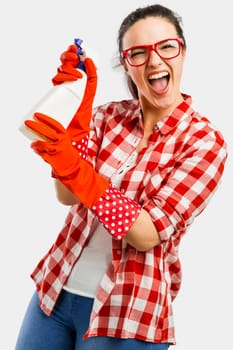Pretty woman wearing gloves, using a cleaning spray and cleaning the house