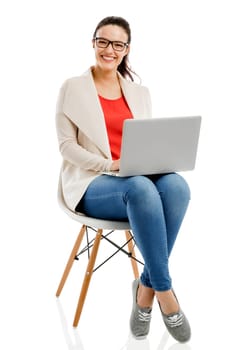 Beautiful and happy woman working with a laptop, isolated over white background