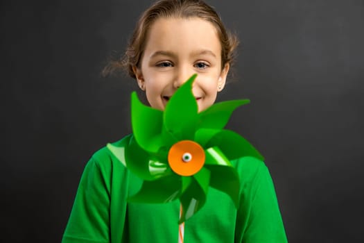 Beautiful little girl smilling and holding a windmill