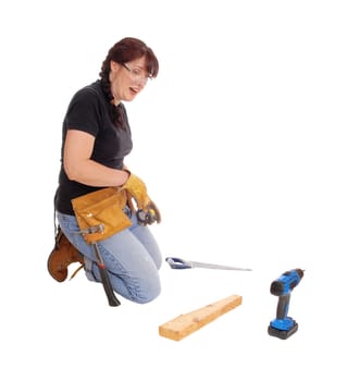 A middle age woman kneeling on the floor and working with some tools,.isolated for white background..