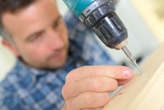 Man using an electric screwdriver