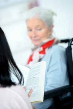 Helping senior woman to read