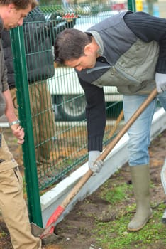 Gardeners putting up a perimeter