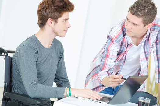 Two male students going over their homework