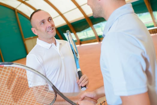 hand shake at the tennis court