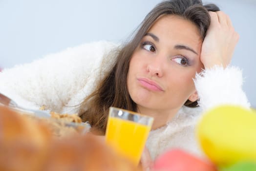 Grumpy woman with orange juice