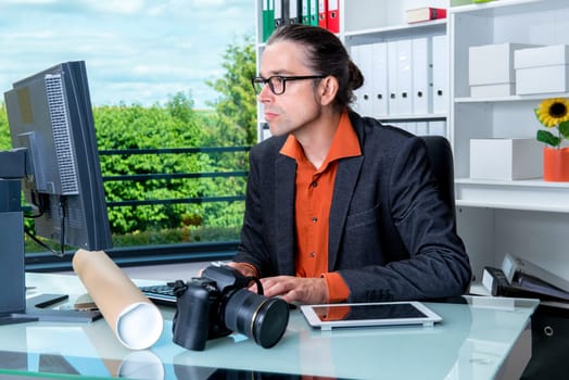 young reporter working in editorial office with computer