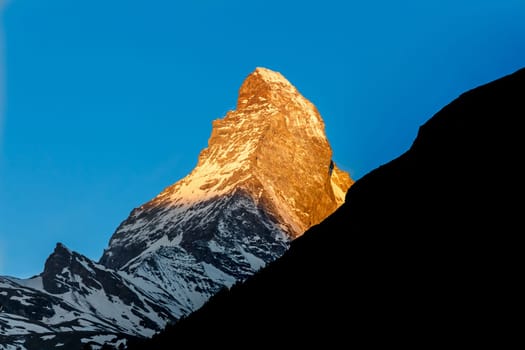 Golden sunlight shine on Matterhorn mountain peak, Zermatt, Switzerland