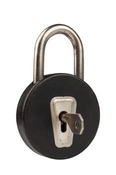 Side view of a vintage black padlock with round shape isolated on white background being open by a key