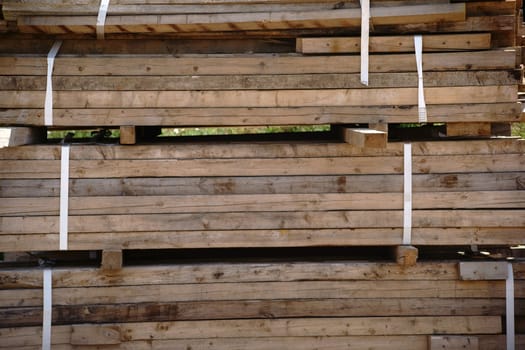 A stack of wooden boards tied together on a construction site.