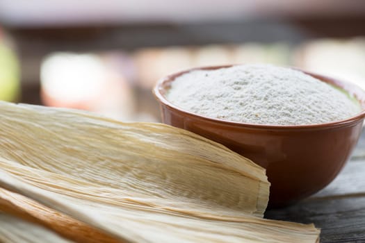 Corn masa flour and corn husks for preparing tamales.