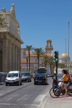 CADIZ, SPAIN - MAY 31, 2010: People on Bicycles Waiting for Crossing the Road in Cadiz, Spain.
