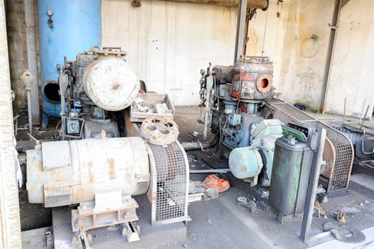 Old abandoned air compressor station, with two electric motor compressors.
