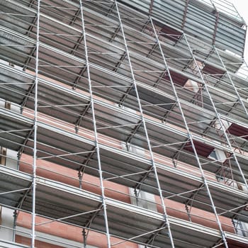 House for renovation with the scaffolding for bricklayers