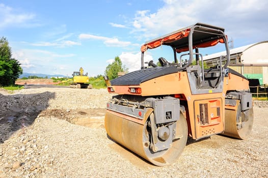 Road roller working at road construction site.