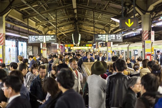 Crowd of people during rush hour on Tokyo metro.