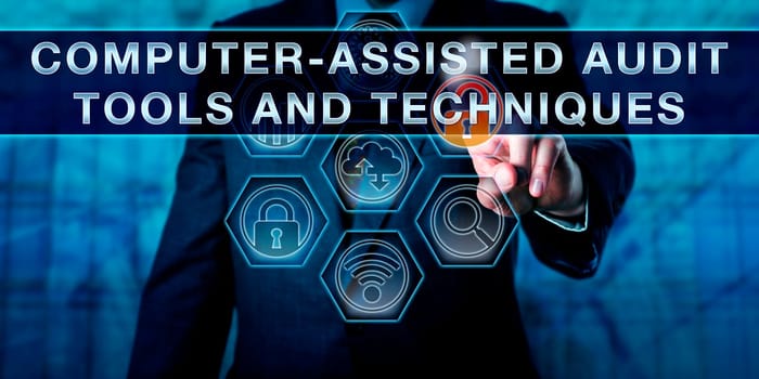 Male corporate manager pressing COMPUTER-ASSISTED AUDIT TOOLS AND TECHNIQUES on an interactive touch screen interface. Business risk metaphor and information technology concept for CAATTs.