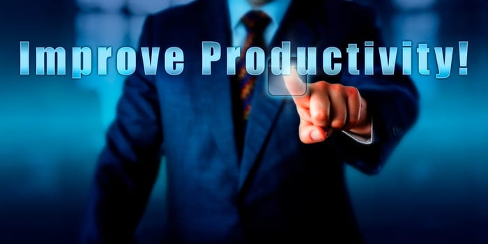 Industrial Manager is pushing the phrase Improve Productivity! on a touch screen. Business objective concept, motivational metaphor, call to a action and management challenge. Close up shot.