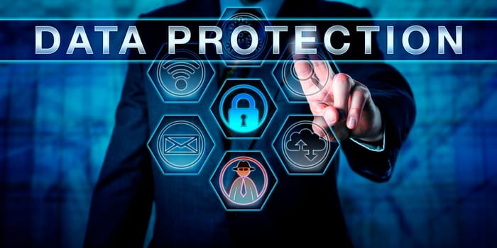 Business manager is pressing DATA PROTECTION on an interactive touch screen interface. Information privacy metaphor and corporate challenge concept for data privacy in networks and cyber space.