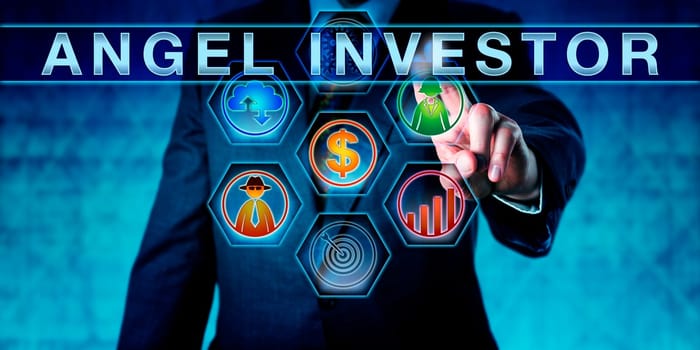 Male entrepreneur is pushing ANGEL INVESTOR on an interactive touch screen. Start up finance concept for business angel, informal investor, angel funder or seed investor, especially the tech sector.