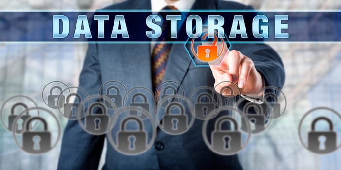Male corporate database manager pressing DATA STORAGE on an interactive control screen. Business metaphor. Information technology concept for computer storage, data security and mass storage media.
