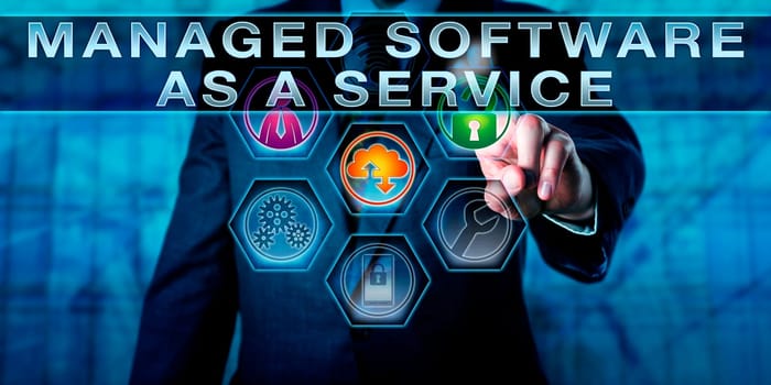 Manager is touching MANAGED SOFTWARE AS A SERVICE on an interactive control screen. Business concept for MSaaS and information technology metaphor for packaged IT solutions.